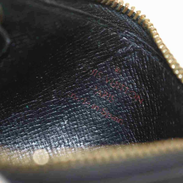 LOUIS VUITTON. Coin purse in black epi leather, Half moo…