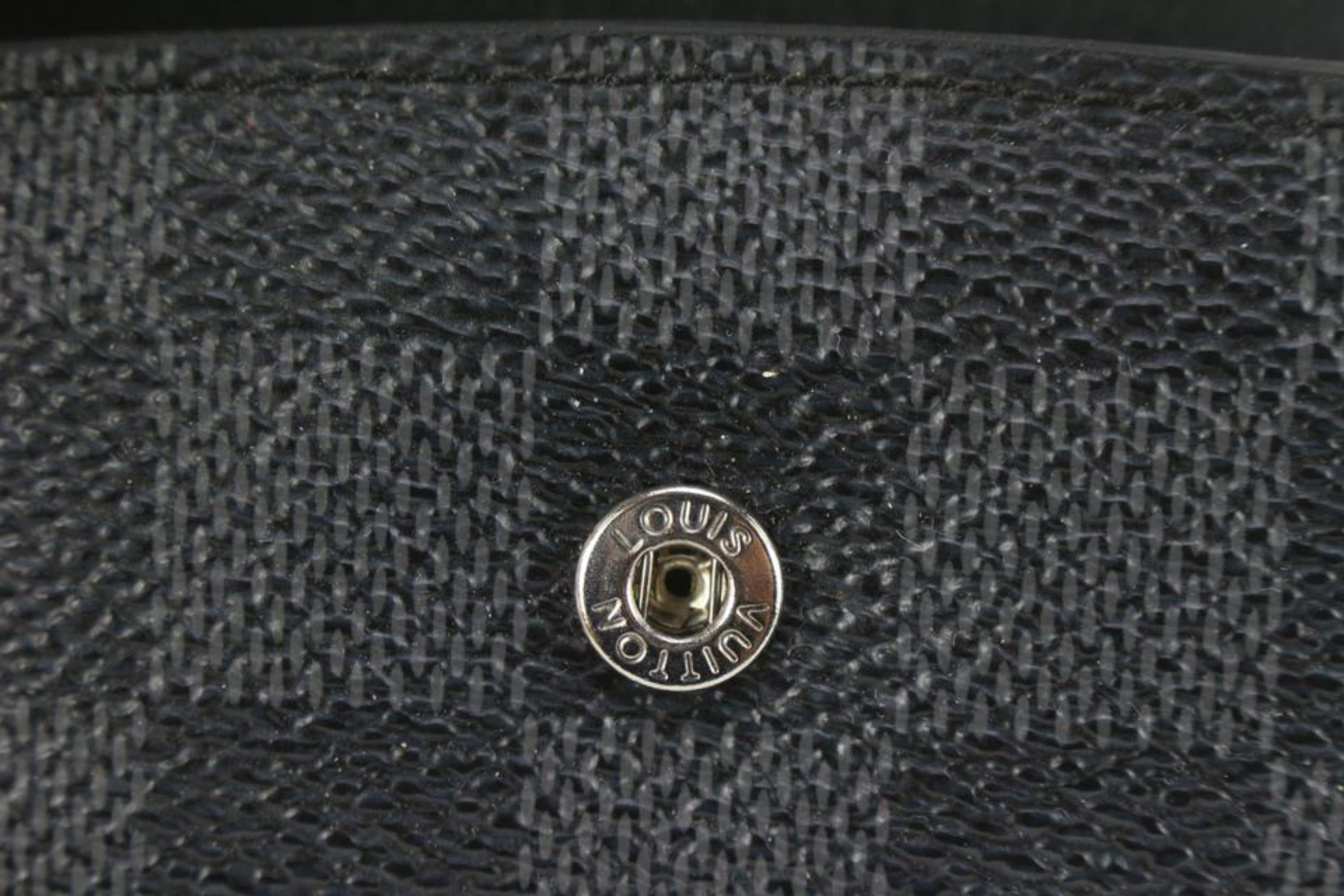 A black damier ebene canvas weekend bag by Louis Vuitton. - Bukowskis